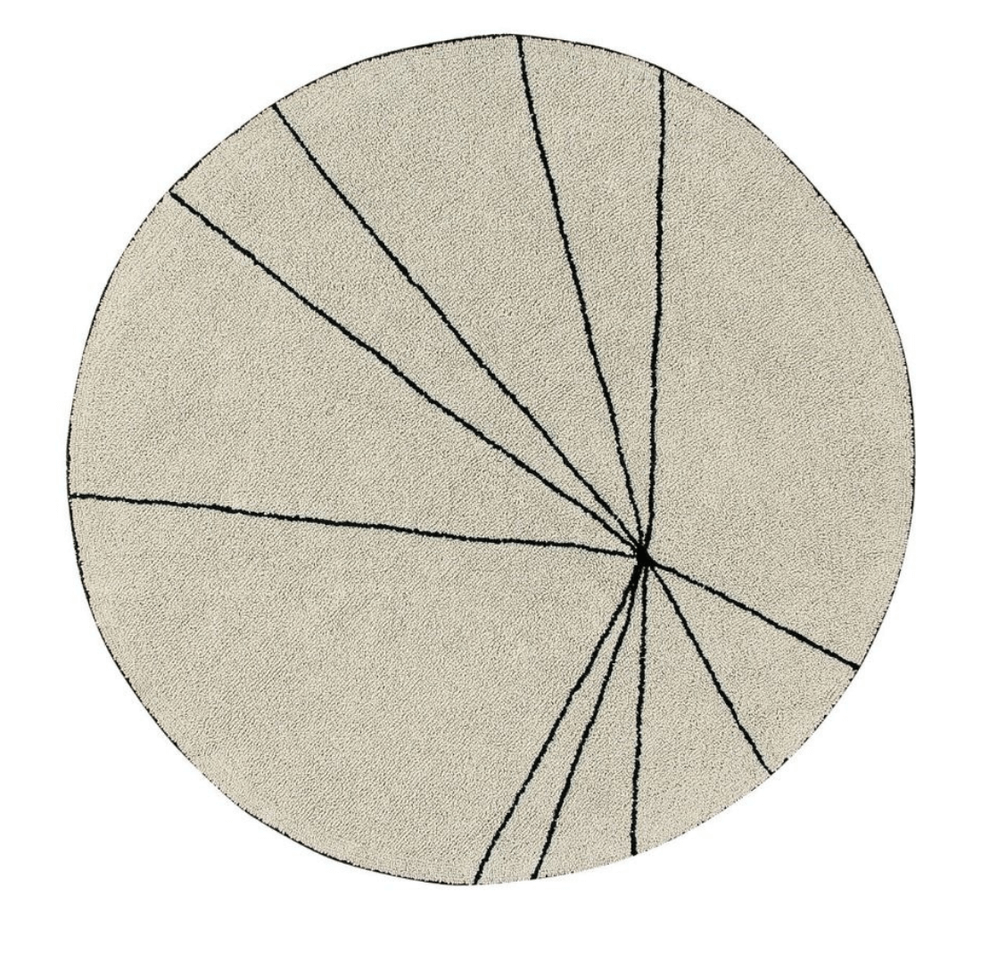 A circular shaped beige cotton rug decorated with geometric black lines