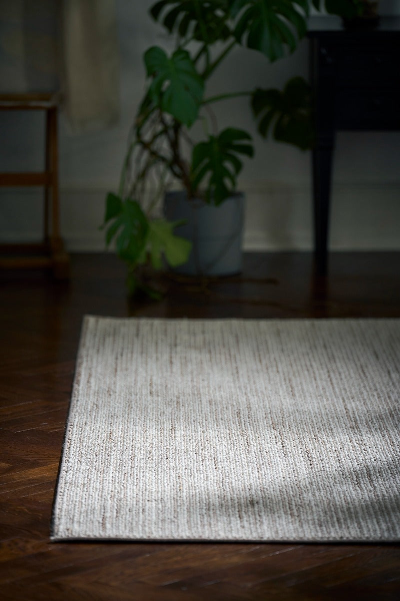 Textured area rug in stone and beige hues