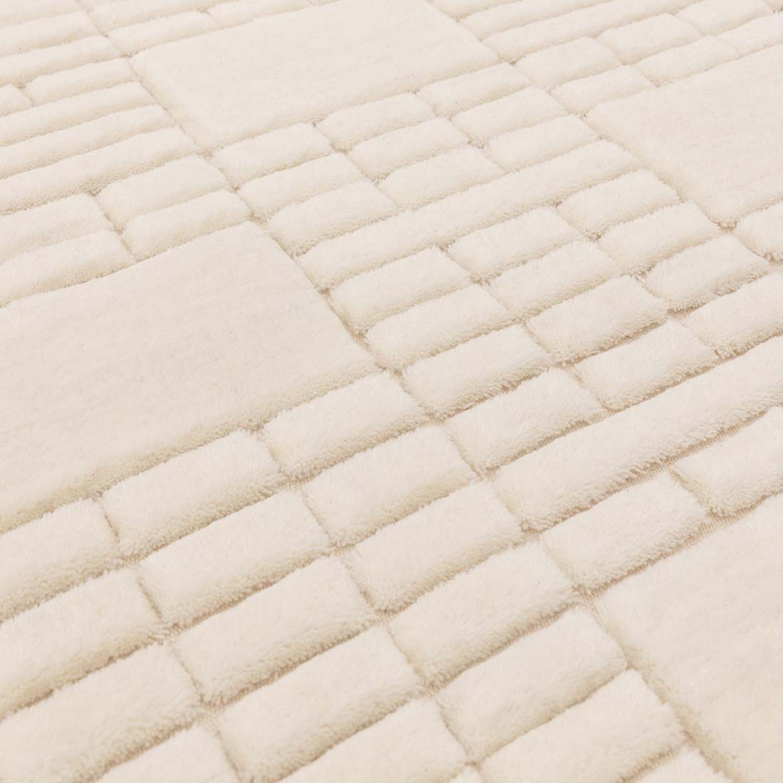 cream wool rug with subtle geometric pattern