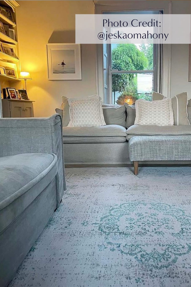 Grey flatweave rug with faded green persian design