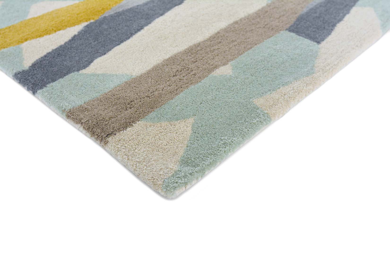mint green wool rug with abstract design in mustard, grey and taupe