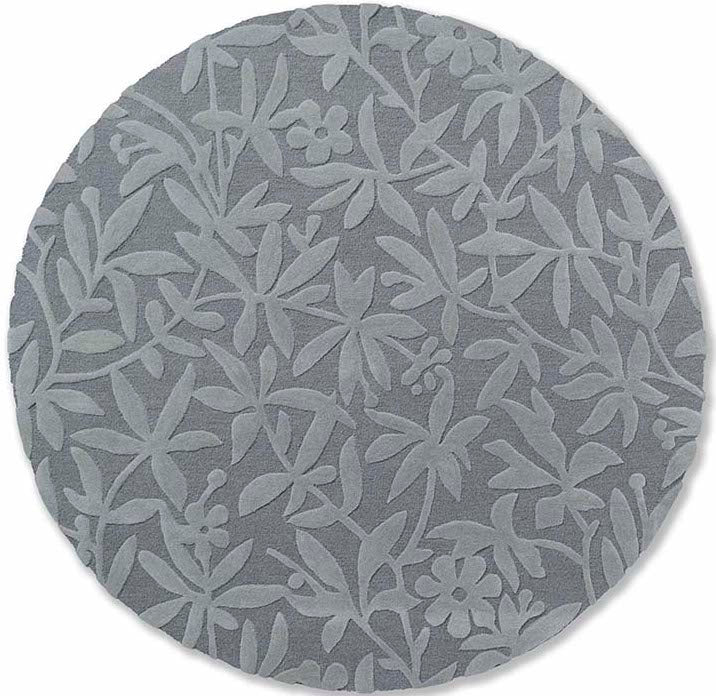 Grey wool circle rug with hand carved floral motifs
