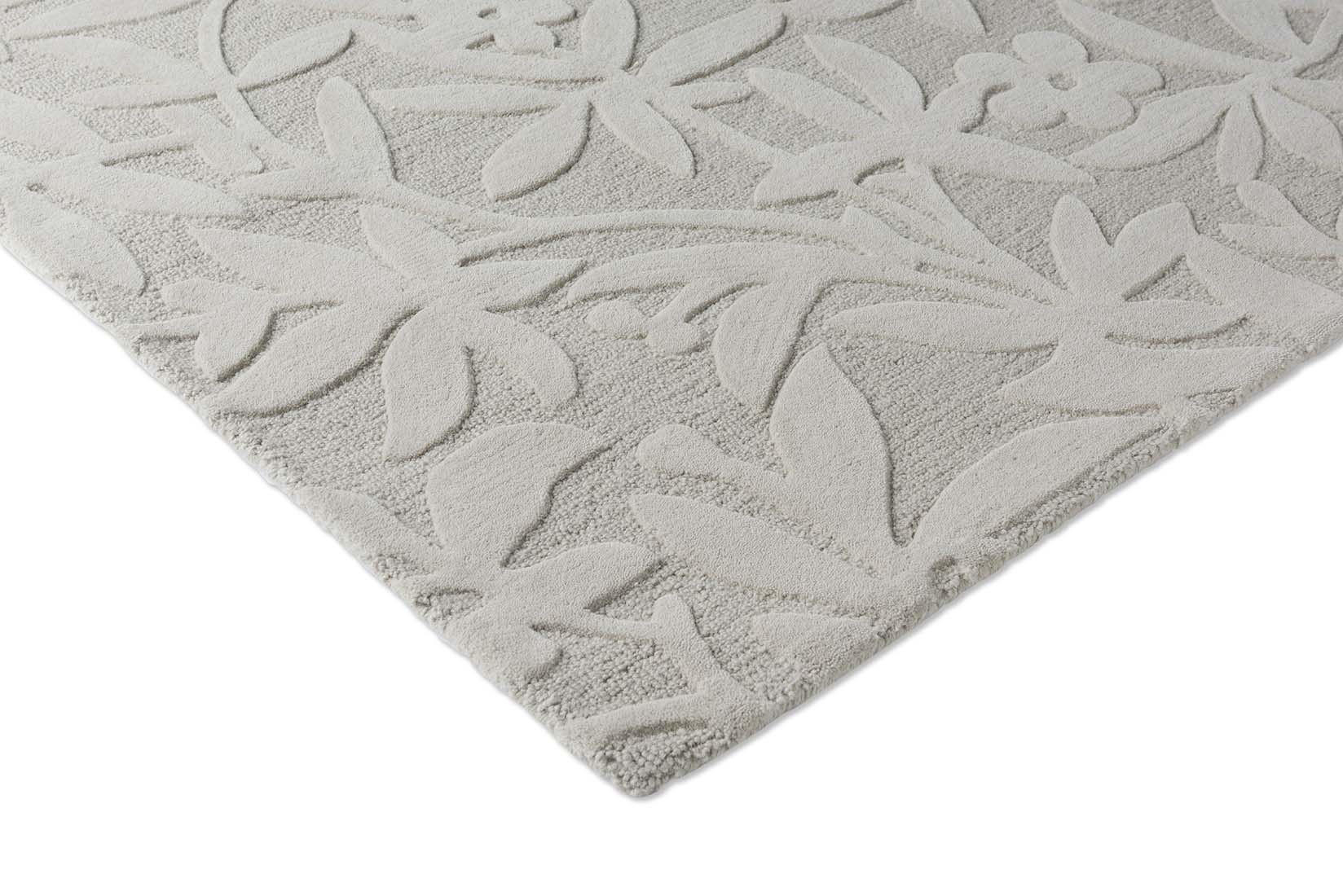 Beige wool rug with hand carved floral motifs