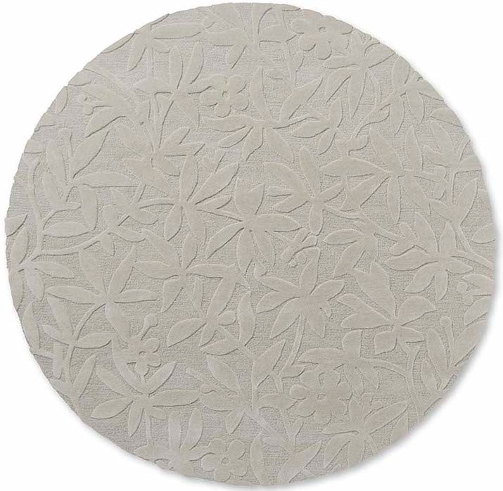 Beige wool circle rug with hand carved floral motifs
