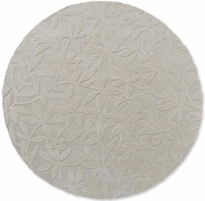 Beige wool circle rug with hand carved floral motifs