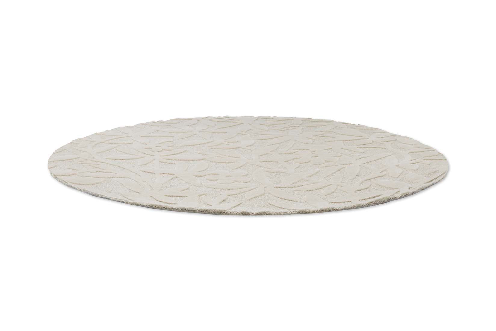 Beige wool circle rug with hand carved floral motifs