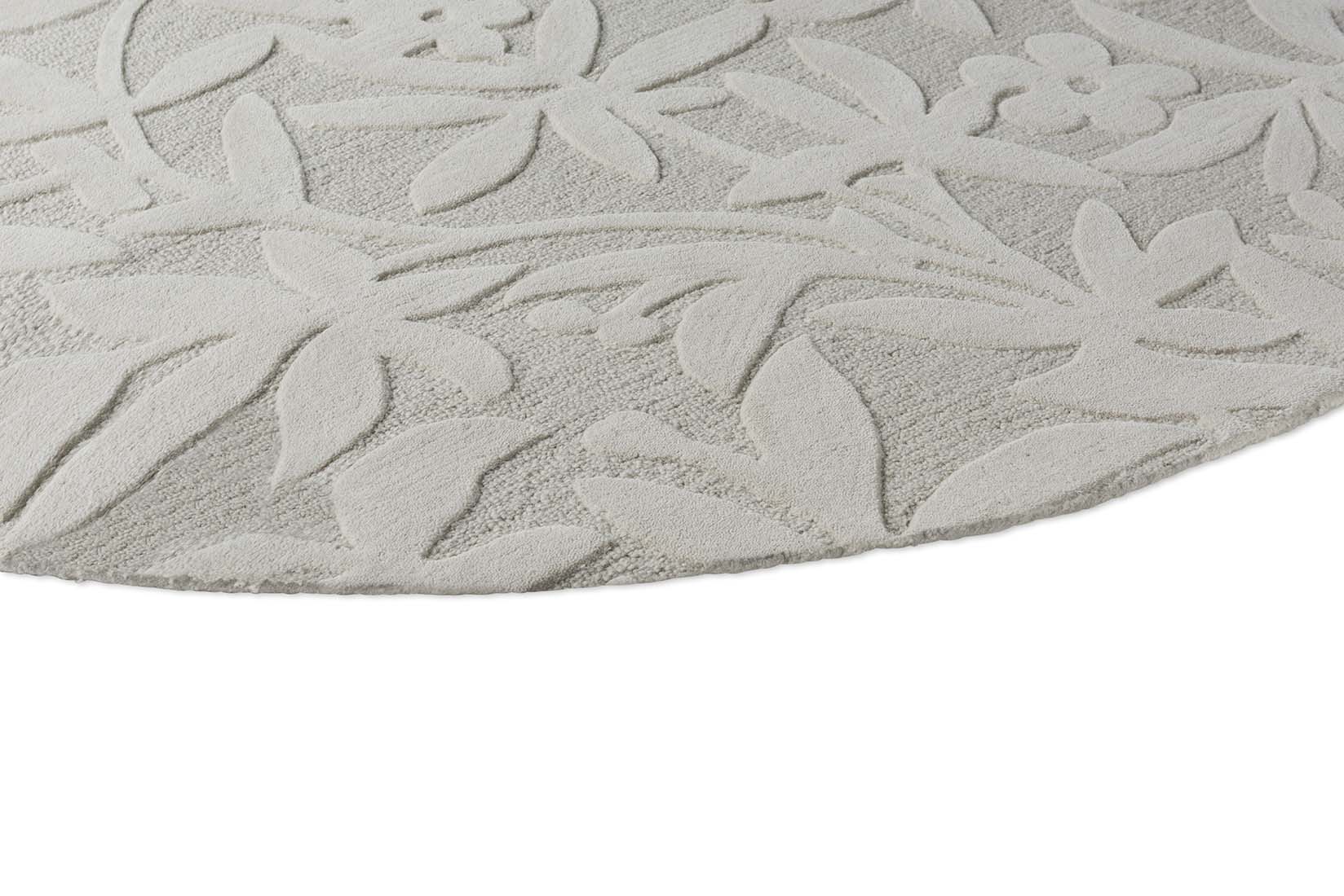 Beige wool circle rug with hand carved floral motifs