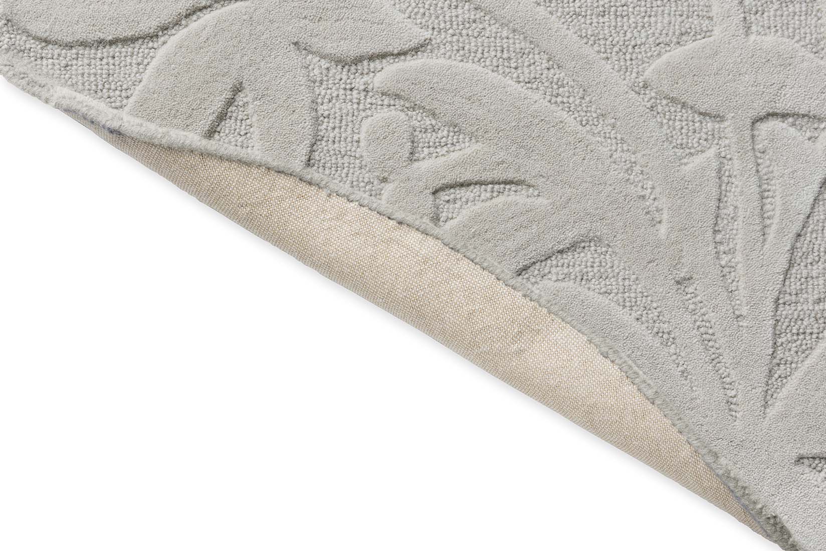 Beige wool circle rug with hand carved floral motifs