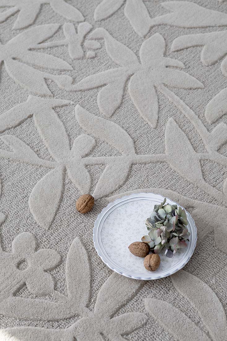 Beige wool rug with hand carved floral motifs