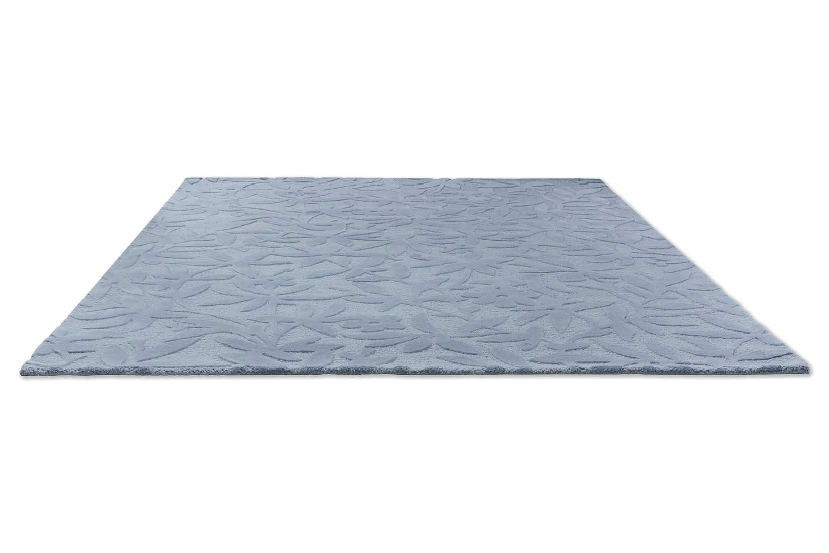 Blue wool rug with hand carved floral motifs