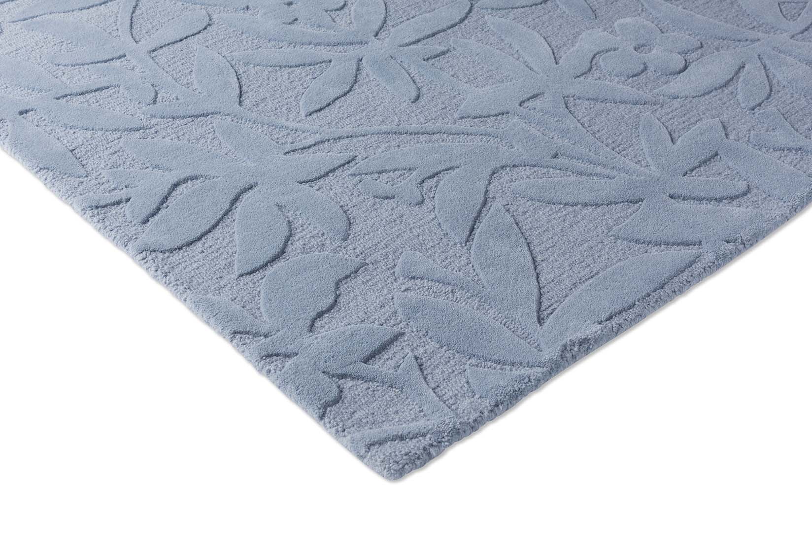 Blue wool rug with hand carved floral motifs
