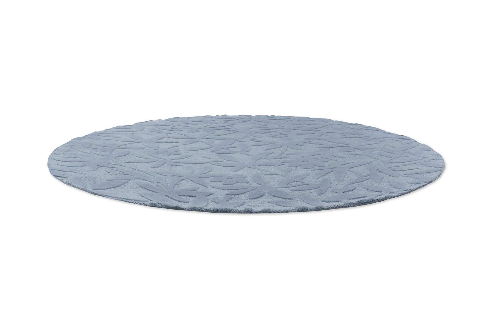Blue wool circular rug with hand carved floral motifs