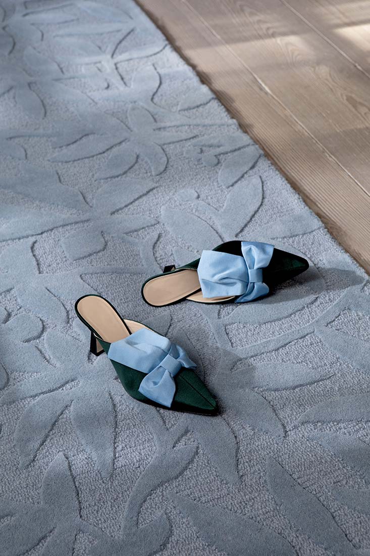 Blue wool rug with hand carved floral motifs