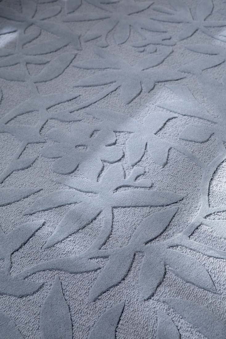 Blue wool rug with hand carved floral motifs