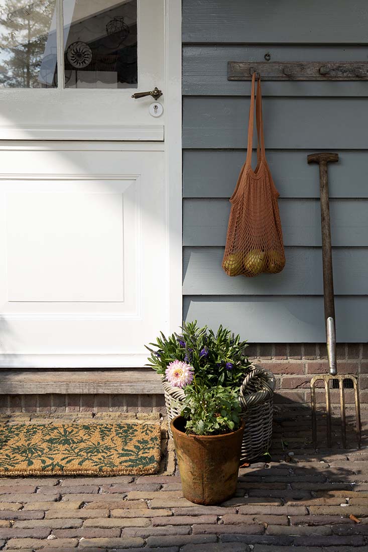 Coir doormat with green floral pattern