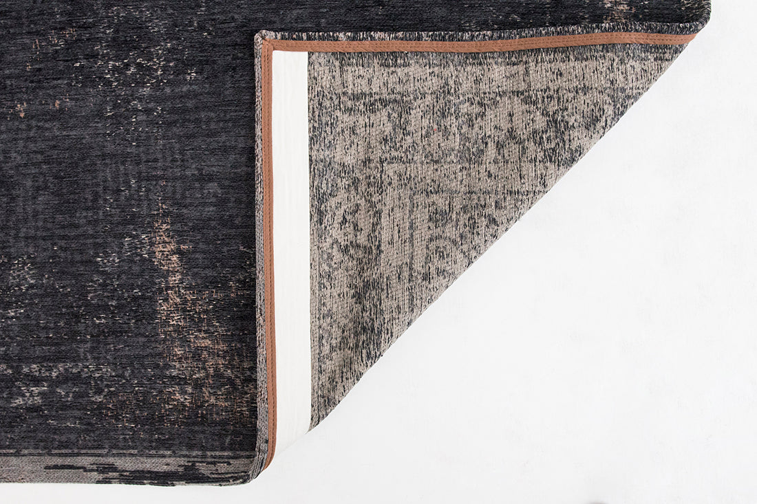 Black flatweave rug with faded persian design