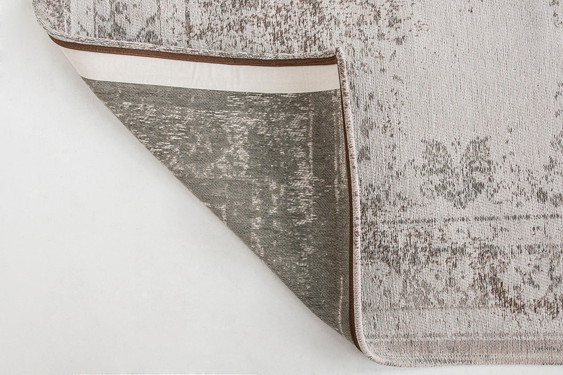 Grey rug with faded persian design