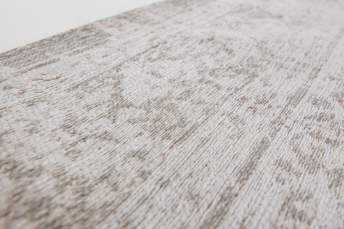 Grey rug with faded persian design