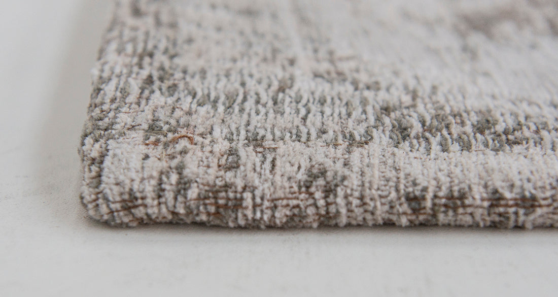 Grey rug with faded persian design