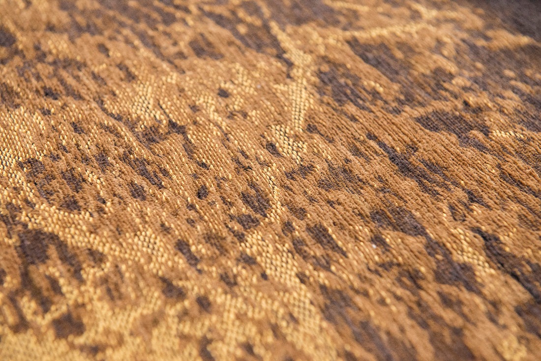 Flatweave rug with faded jagged abstract design in copper and charcoal