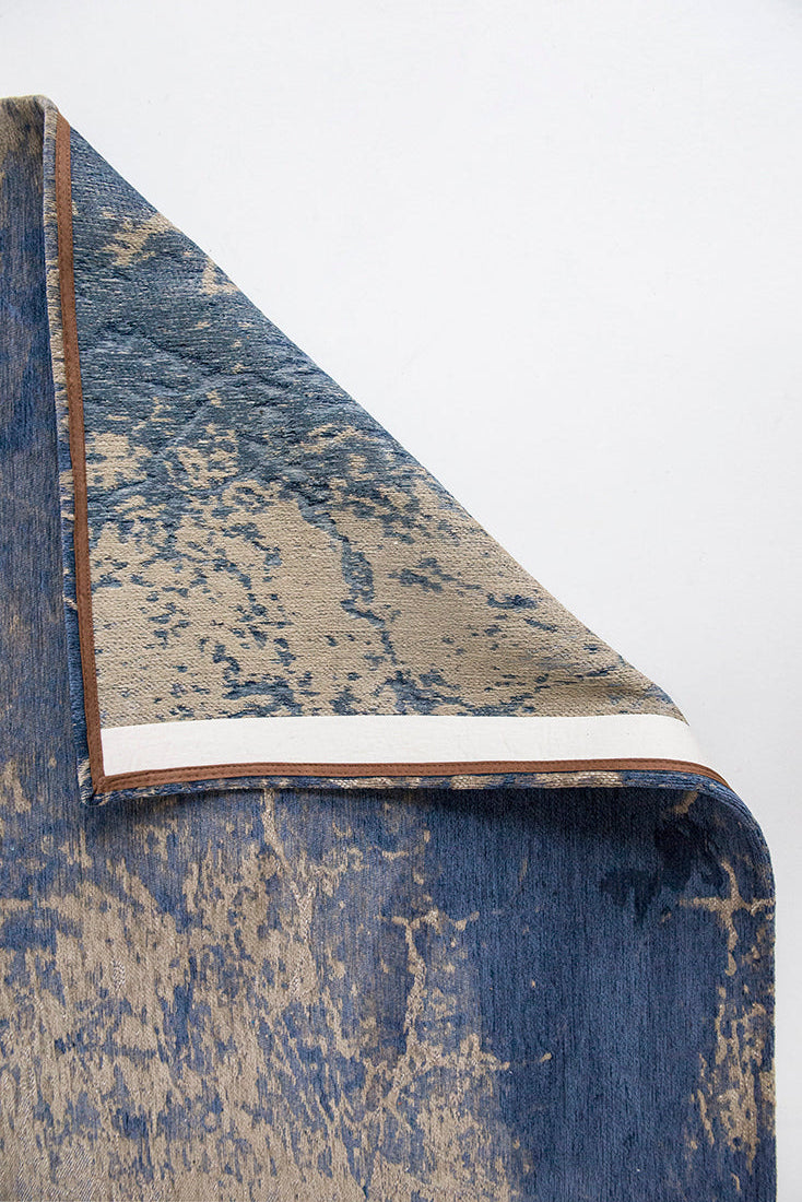 Flatweave rug with faded jagged abstract design in beige and blue