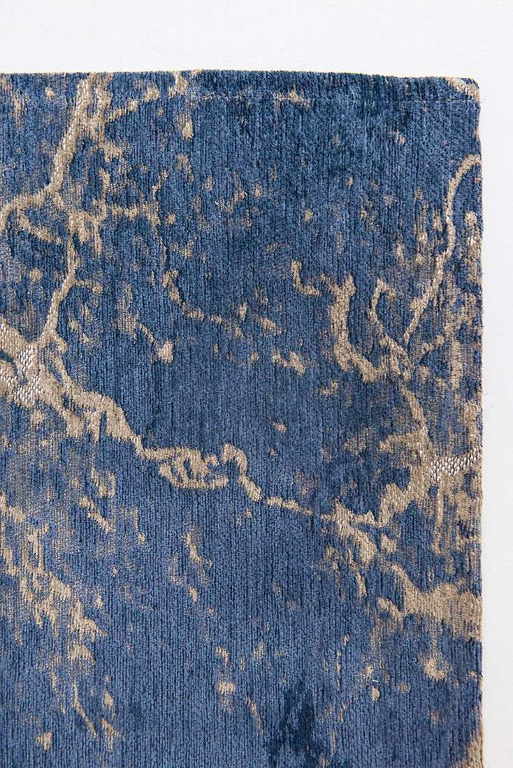 Flatweave rug with faded jagged abstract design in beige and blue