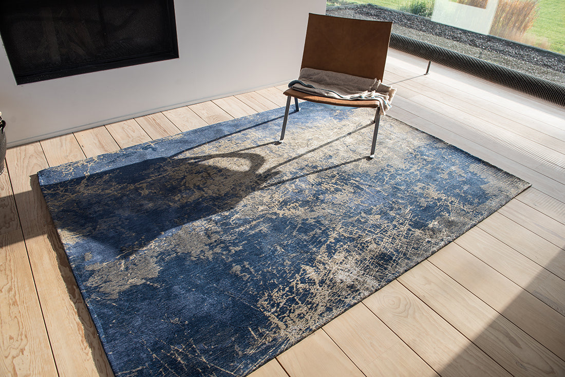 Flatweave rug with faded jagged abstract design in beige and blue