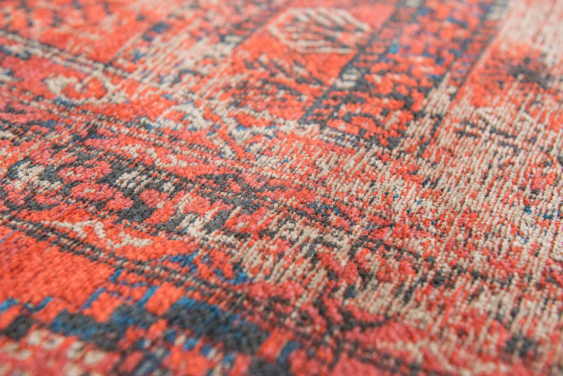 Red flatweave rug with faded persian design of floral motifs and gul medallions