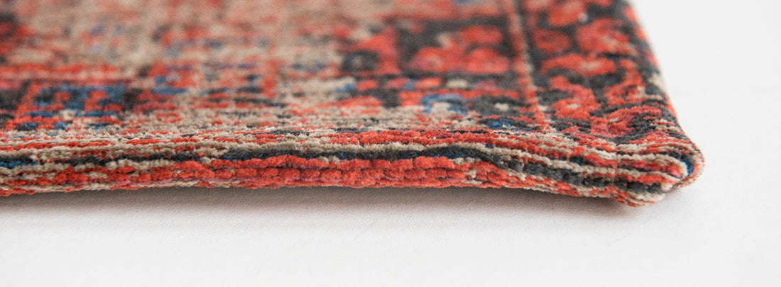 Red flatweave rug with faded persian design of floral motifs and gul medallions