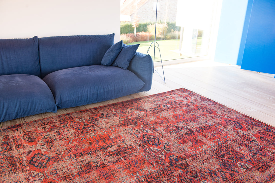 Red flatweave rug with faded persian design of floral motifs and gul medallions