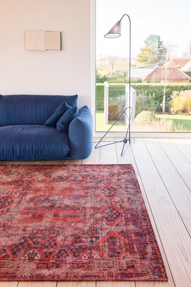 Red flatweave rug with faded persian design of floral motifs and gul medallions