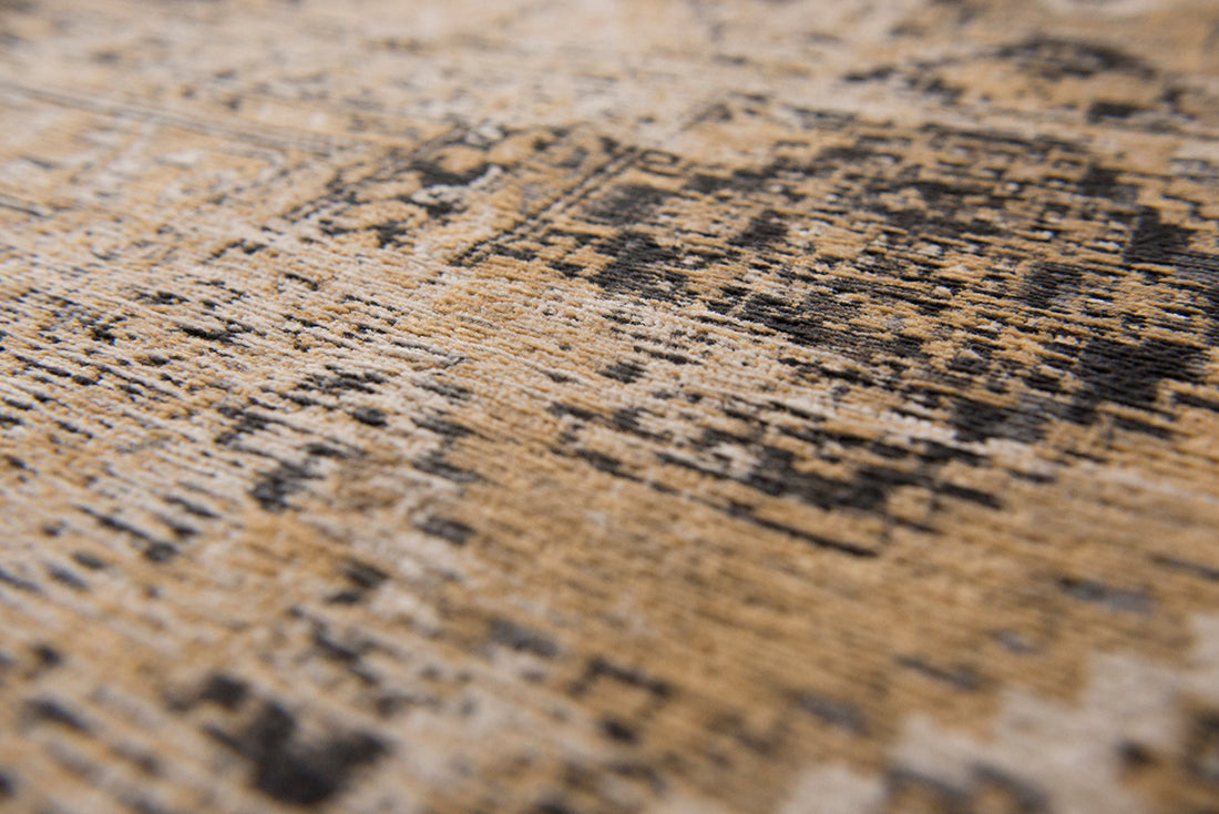 Gold and beige flatweave rug with faded persian design of floral motifs and gul medallions