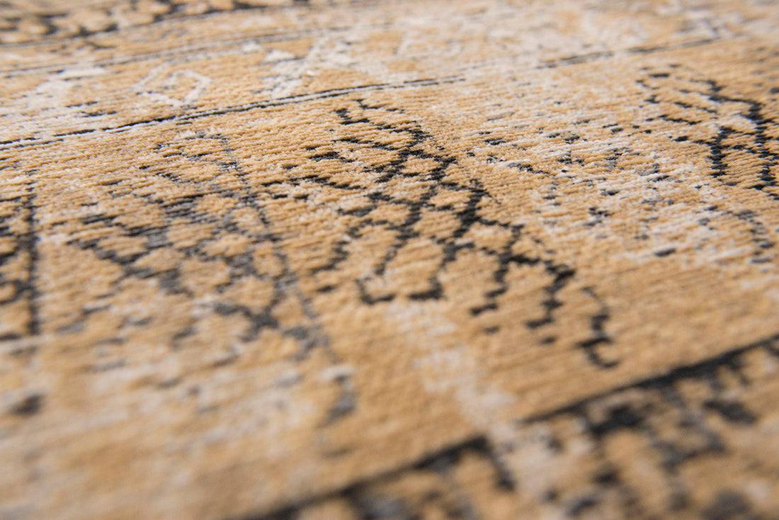 Gold and beige flatweave rug with faded persian design of floral motifs and gul medallions