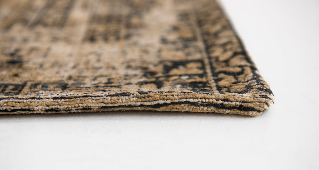 Gold and beige flatweave rug with faded persian design of floral motifs and gul medallions