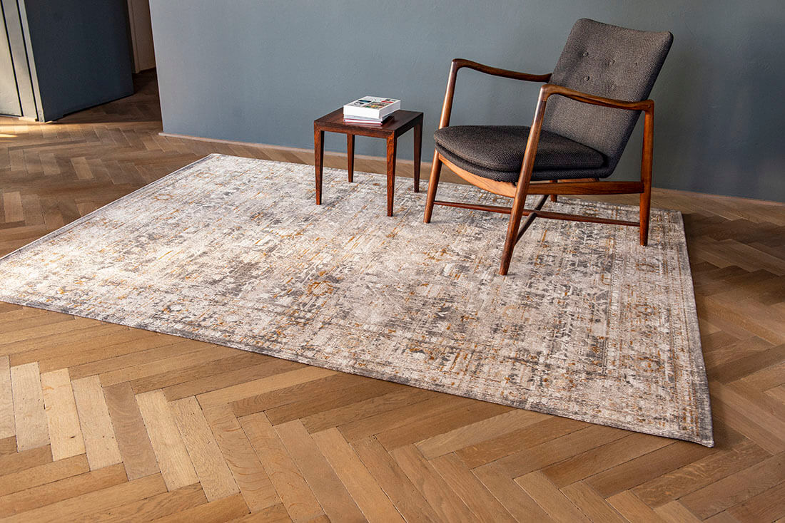 Distressed beige rug with turkish floral medallions and border in gold and grey