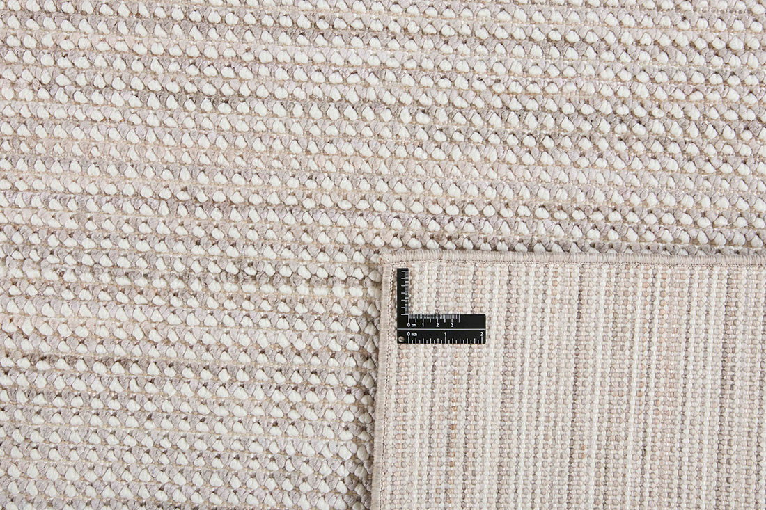 Textured area rug in stone and beige hues