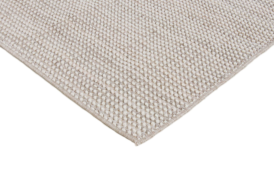 Textured area rug in stone and beige hues