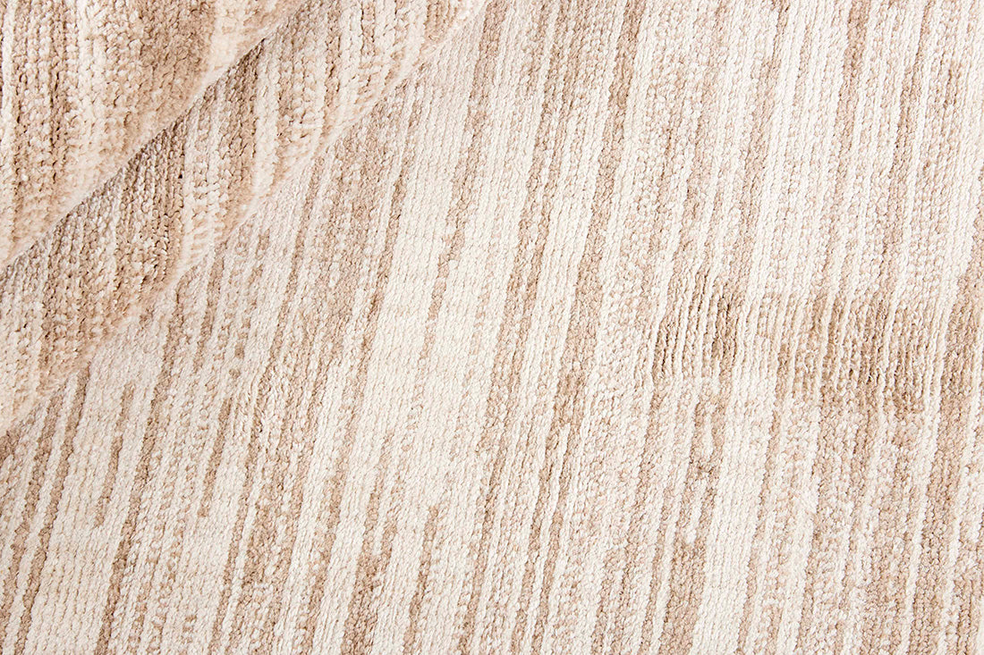Cream rug with a subtle striped beige pattern 
