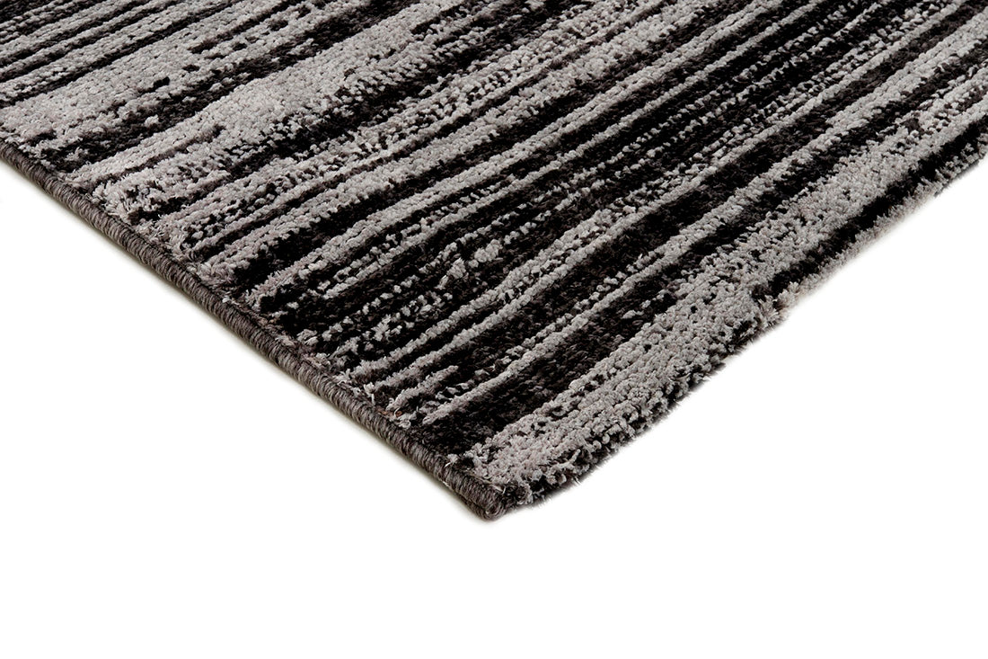 Grey rug with a subtle striped black pattern 

