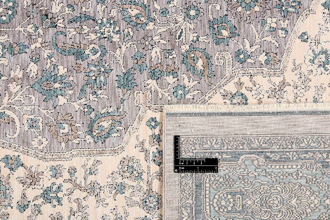 Traditional style rug with beige backing and jade patterned border design