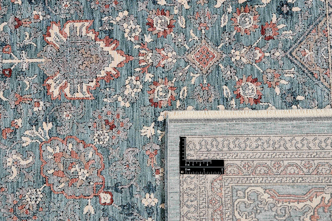 Traditional style rug with green backing and patterned border design