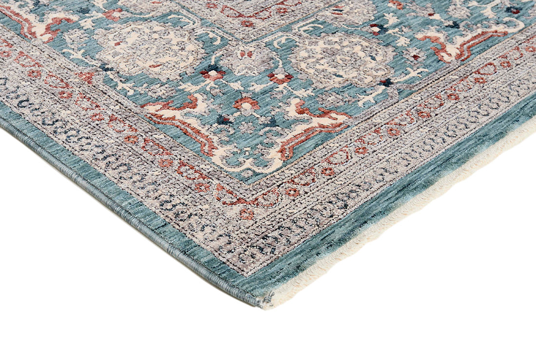 Traditional style rug with green backing and patterned border design