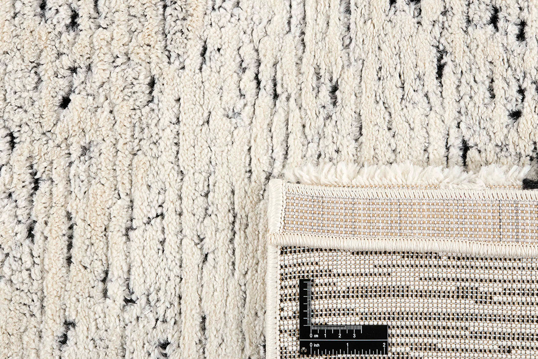 Plain cream Moroccan style rug with dark undertones