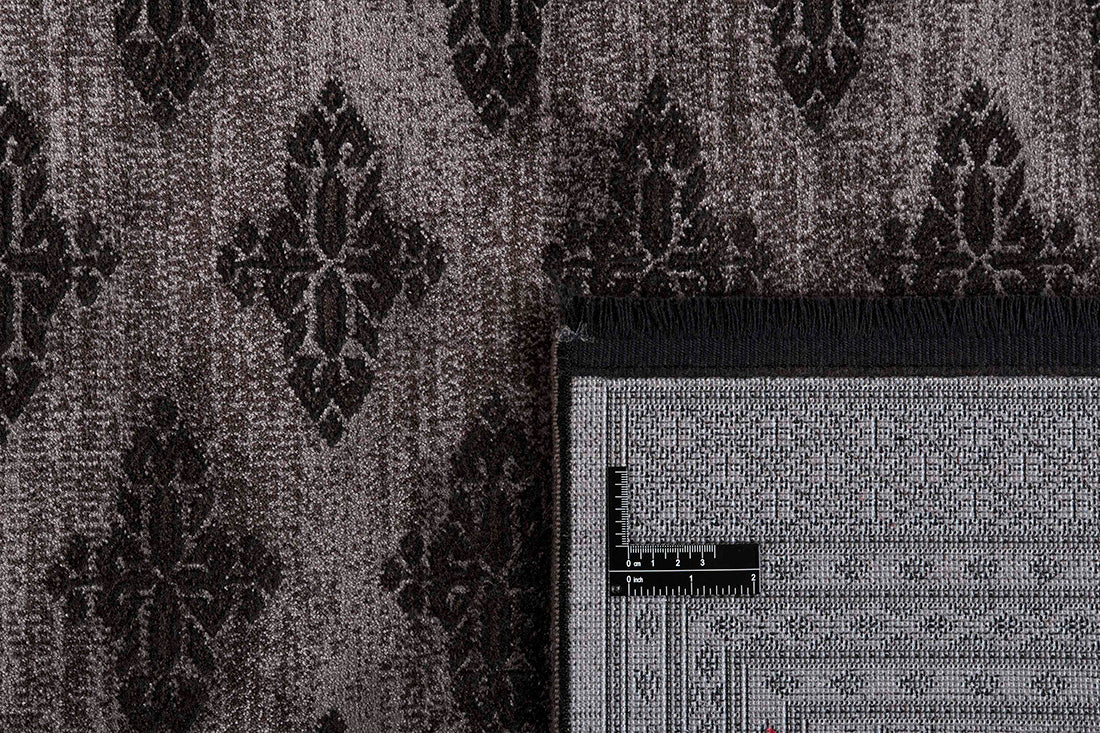 Traditional Bokhara style rug with border. In shades of black
