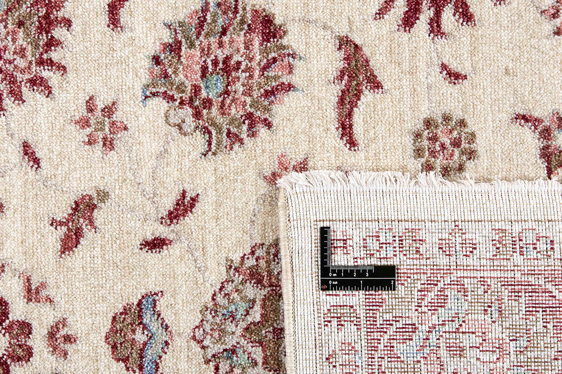 Traditional red bordered Ziegler-style rug with floral motif