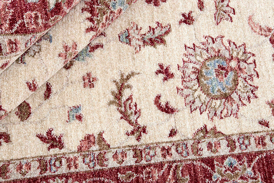 Traditional red bordered Ziegler-style rug with floral motif