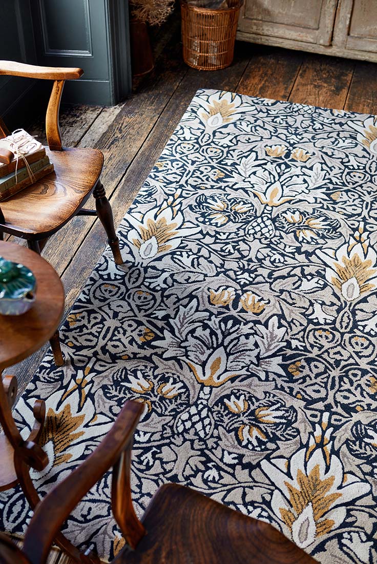 navy and beige coloured floral wool rug
