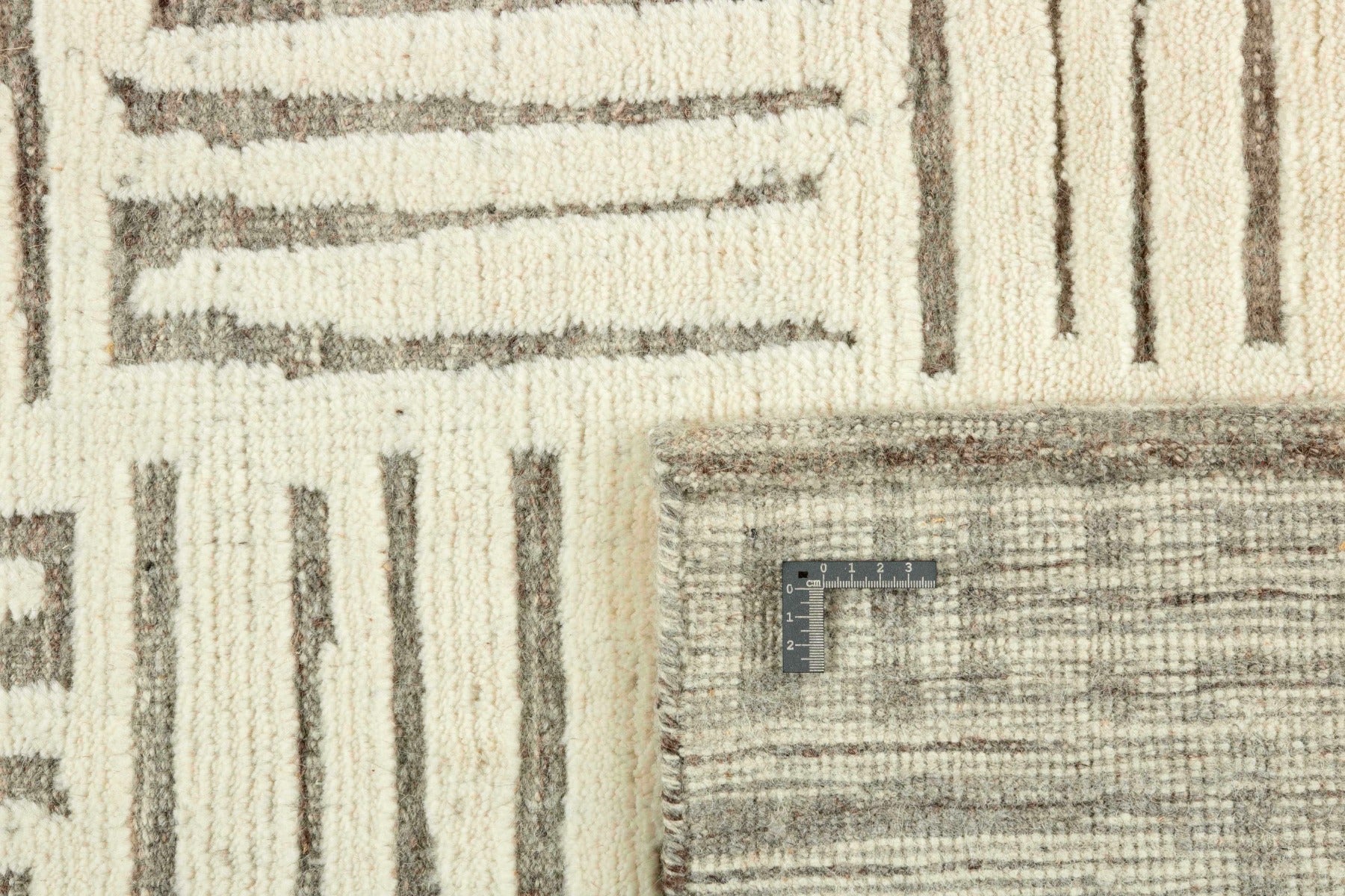 beige area rug with geometric pattern