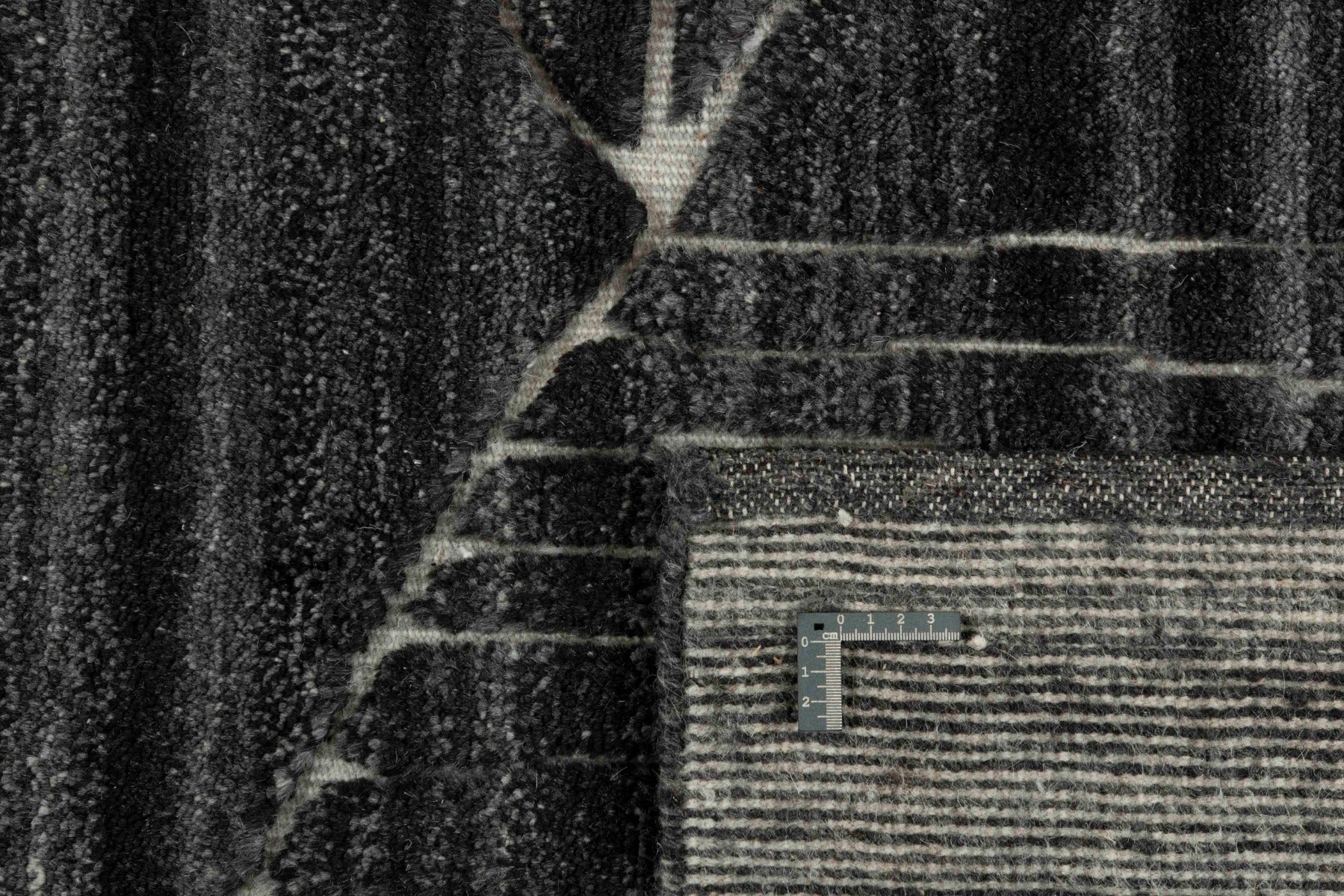 dark grey area rug with abstract design