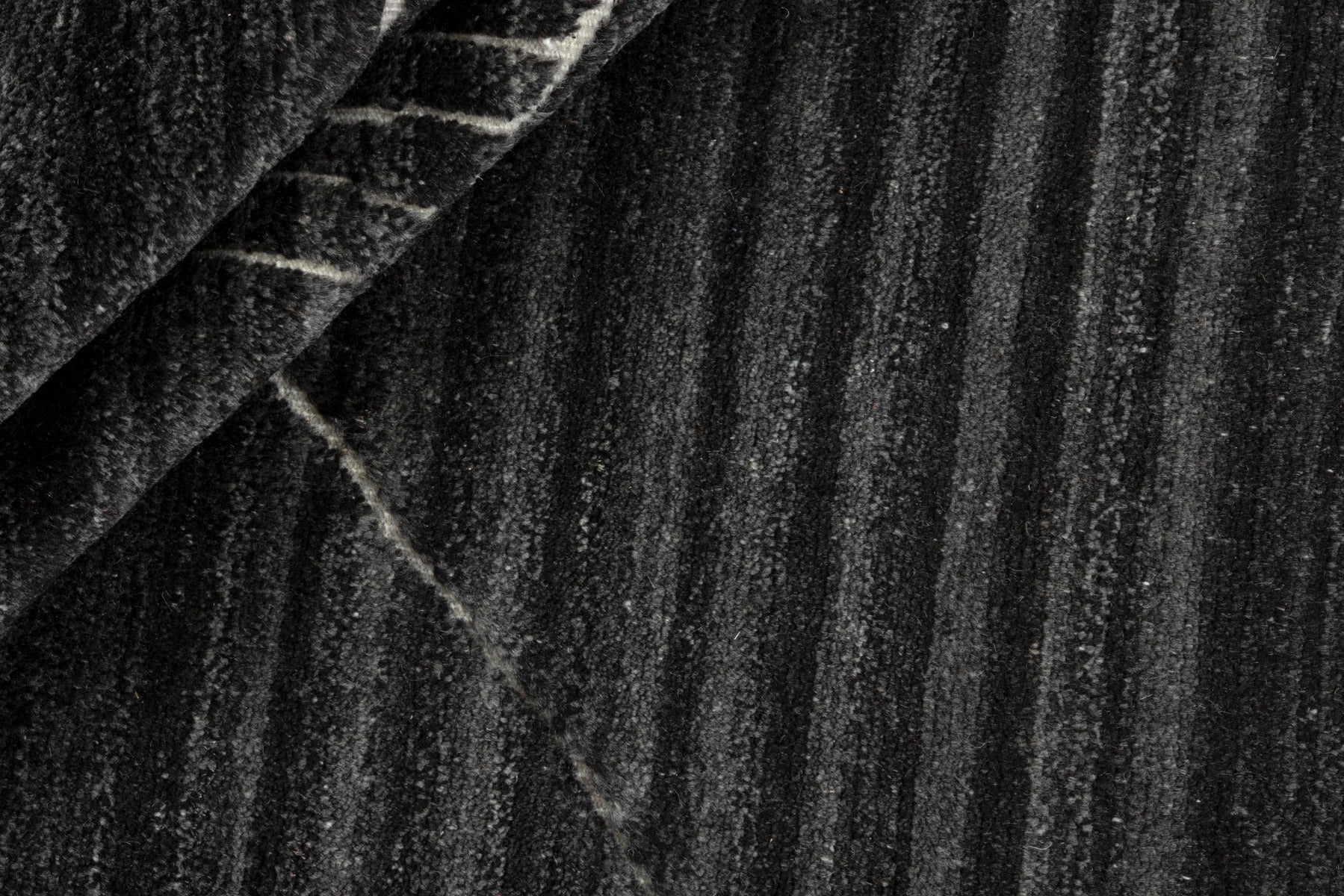 dark grey area rug with abstract design